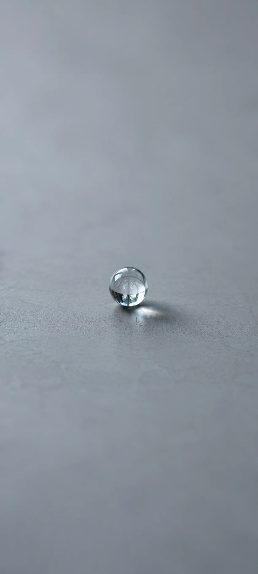Tiny Glass Sphere On Gray