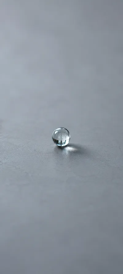 Tiny Glass Sphere On Gray